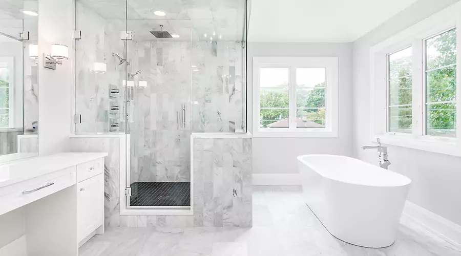 Elegant marble bathroom with glass shower and freestanding tub
